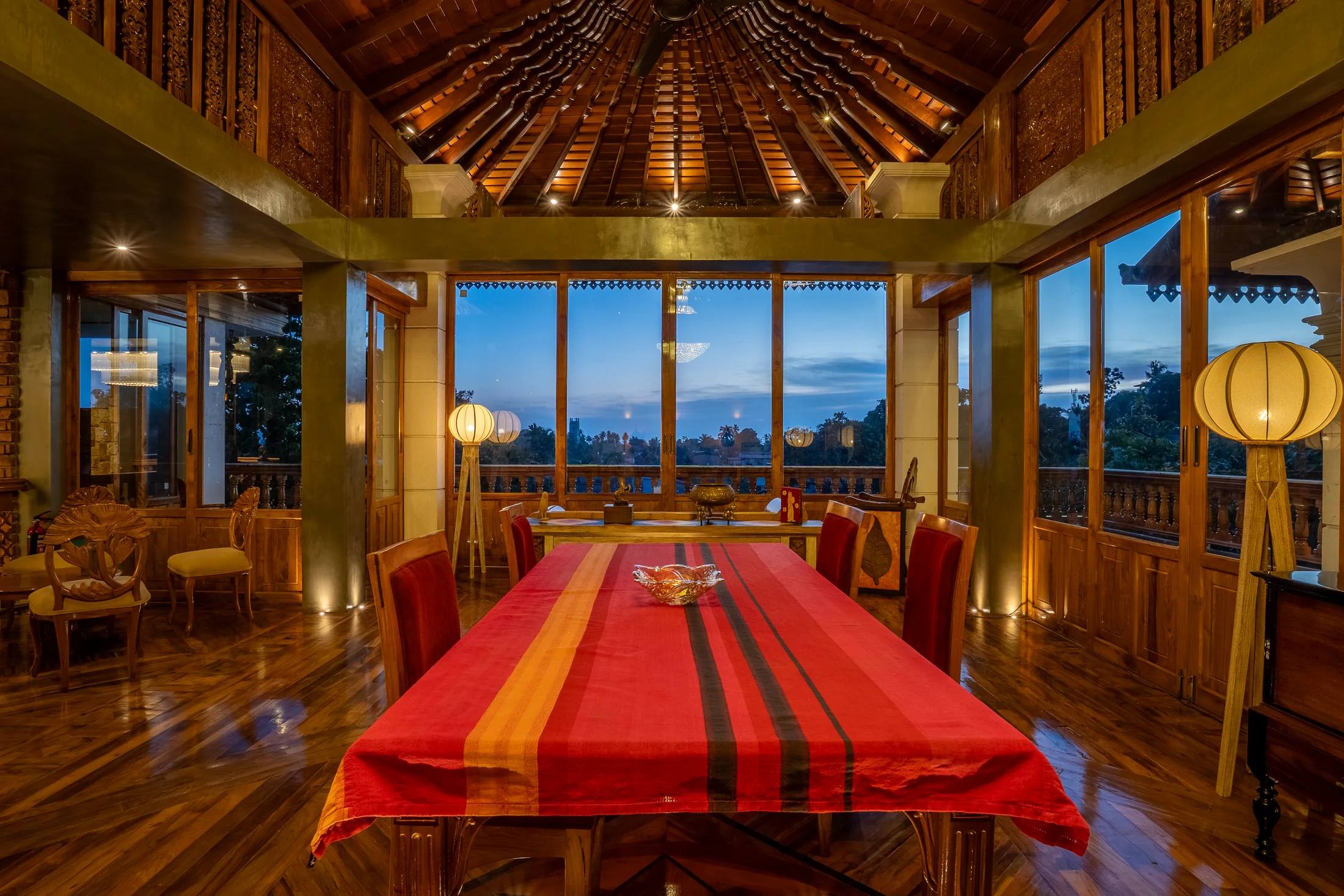 Long private dining table beneath the soaring crafted timber roof