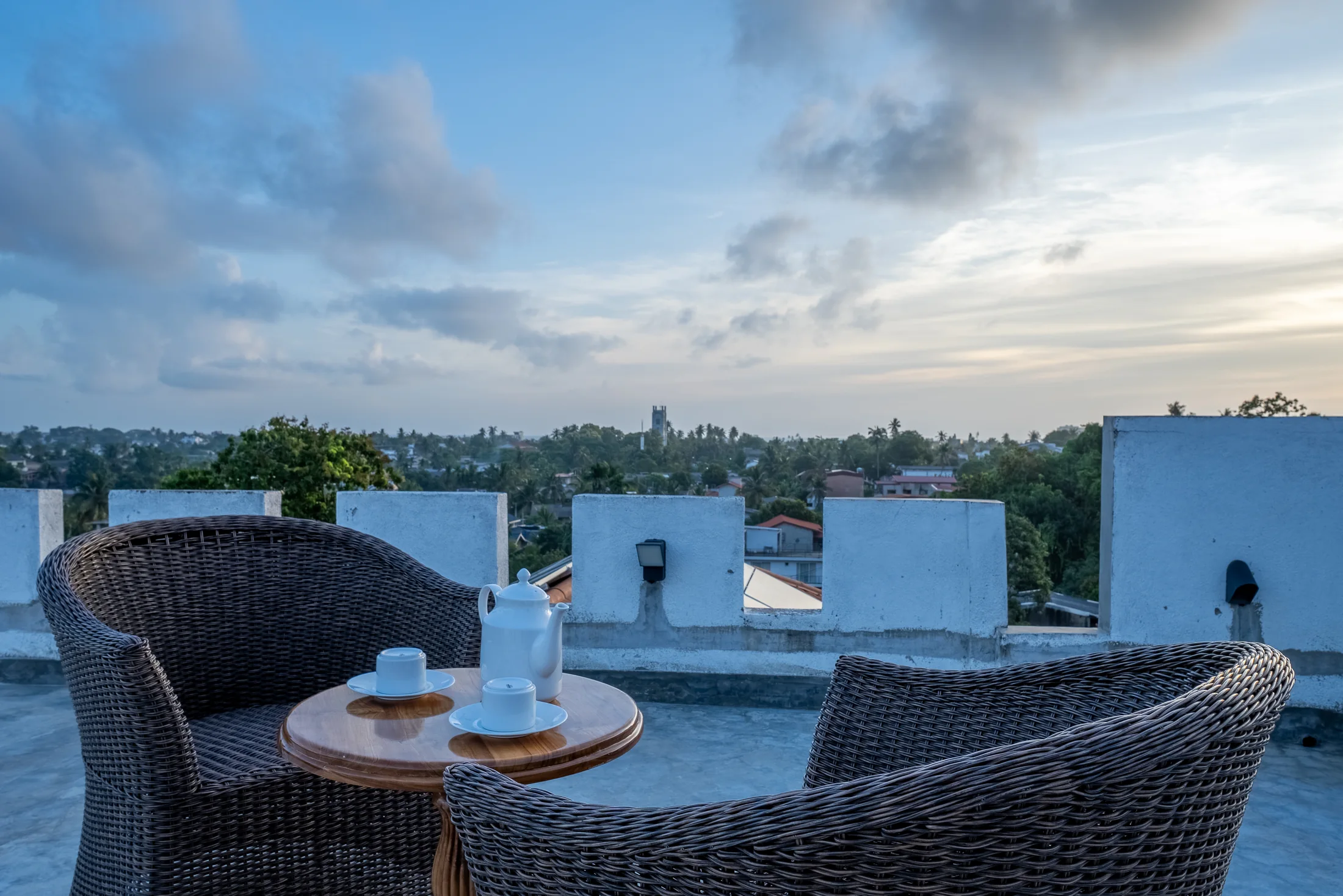 Open rooftop seating with a panoramic evening skyline